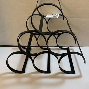 Black metal wine bottle holder. Holds six bottles